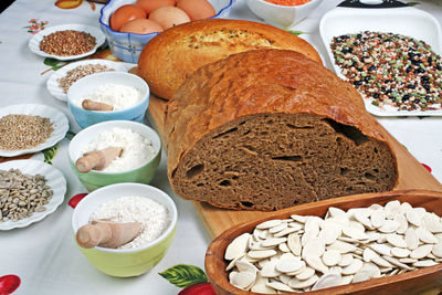 Close-up of bread and ingredients on tablecloth