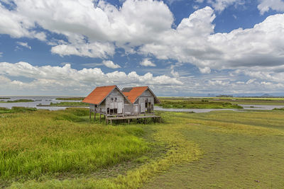 House on field against sky