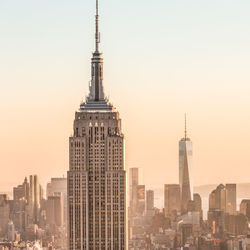 Modern buildings in city against clear sky