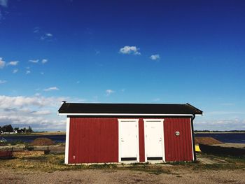 Built structure on field against blue sky