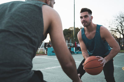 Young man playing with basketball