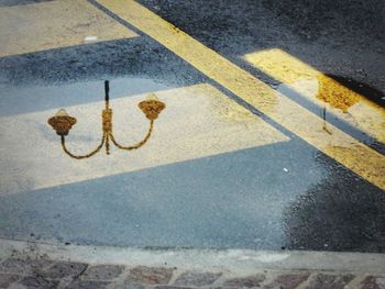 Reflection of lamp post in puddle