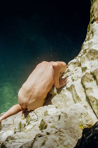 High angle view of hand on rock