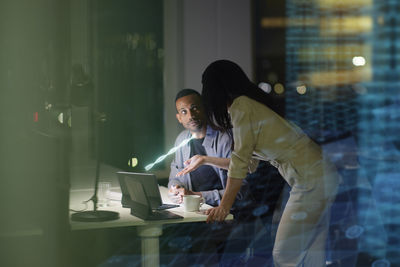 Two young business people working together in office
