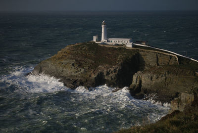 Scenic view of sea by buildings against sky