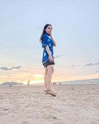 Full length of young woman on beach