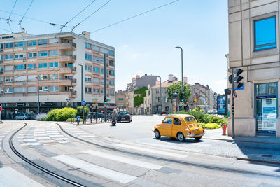 City street and buildings against sky