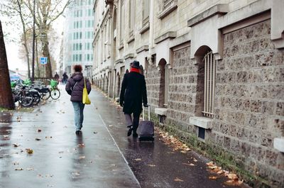 Rear view of woman walking on street