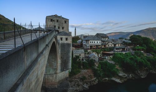 Bridge over mountain against sky