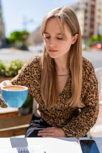 Portrait of young woman using mobile phone