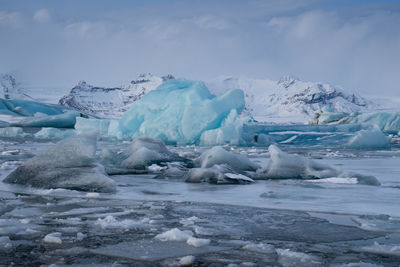 Ice in lagoon against sky