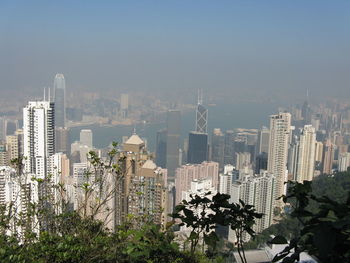 Buildings in city against clear sky