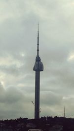 Low angle view of communications tower against sky