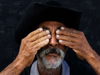 Close-up portrait of man with hands