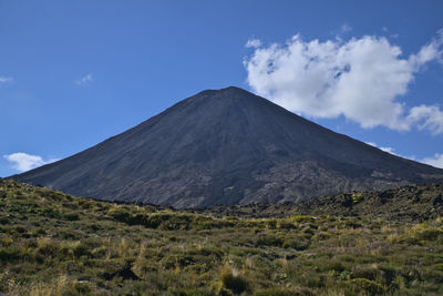 View of volcanic landscape against cloudy sky