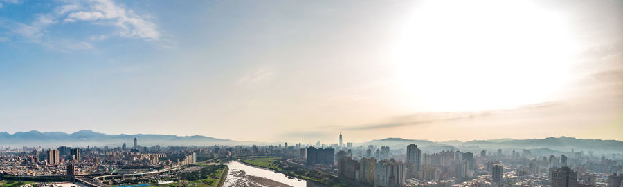 Panoramic view of buildings in city against sky