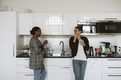 Friends standing at home