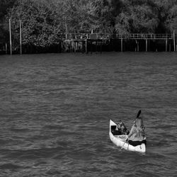 People sitting on boat sailing in sea