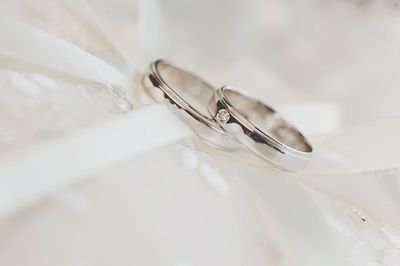 Close-up of wedding rings on cushion