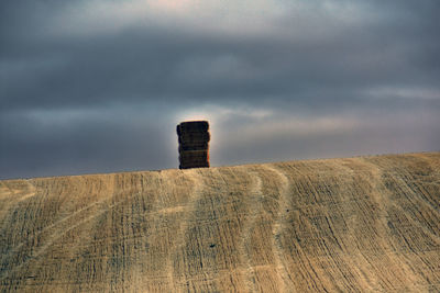 Built structure on landscape against sky