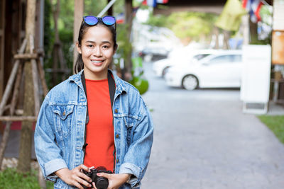 Portrait of smiling girl standing outdoors