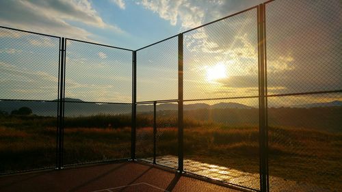 Chainlink fence at sunset