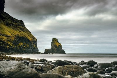 Rocks on beach against sky