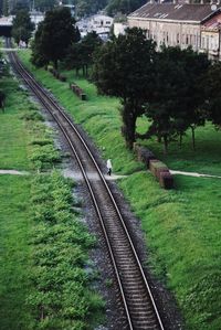Railway tracks by trees against sky