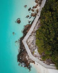 Directly above shot of footbridge by sea