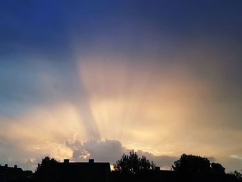 Low angle view of silhouette buildings against sky during sunset