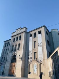 Low angle view of building against clear blue sky
