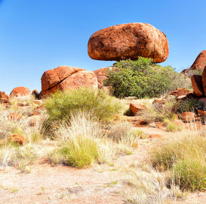 Rock formation on field against clear sky