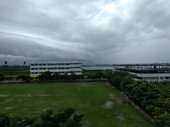 View of buildings in city against cloudy sky