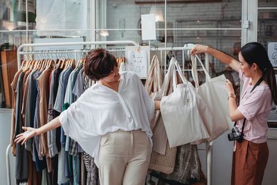 Friends standing in front of store