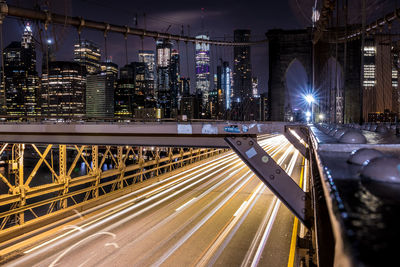 Light trails on bridge in city at night