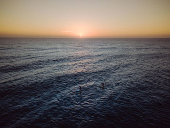 Scenic view of sea against clear sky during sunset