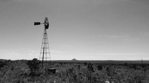 Low angle view of windmill on field against sky