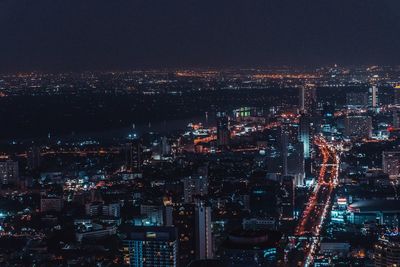 High angle view of illuminated city buildings at night