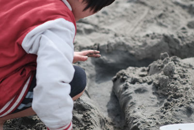 Low section of boys standing on sand