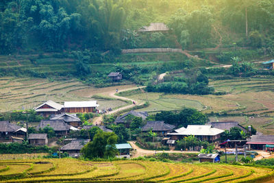 Scenic view of village and houses on field