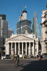 View of city street and buildings against sky