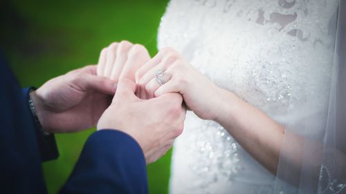 Close-up of cropped hand holding hair