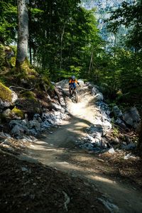 Woman riding a mountain bike on a flow trail in a bike park in glarus, switzerland.