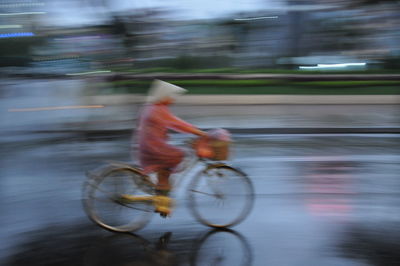 Blurred motion of man riding bicycle
