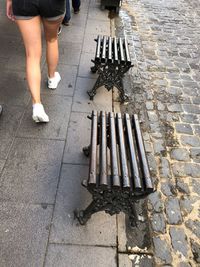 Low section of woman walking on footpath