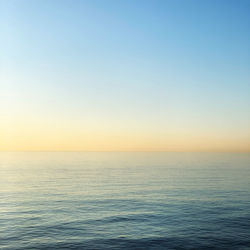 Scenic view of sea against clear sky during sunset