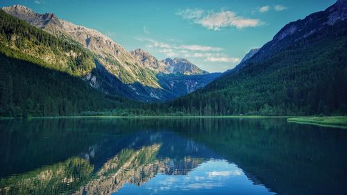 Scenic view of lake and mountains against sky