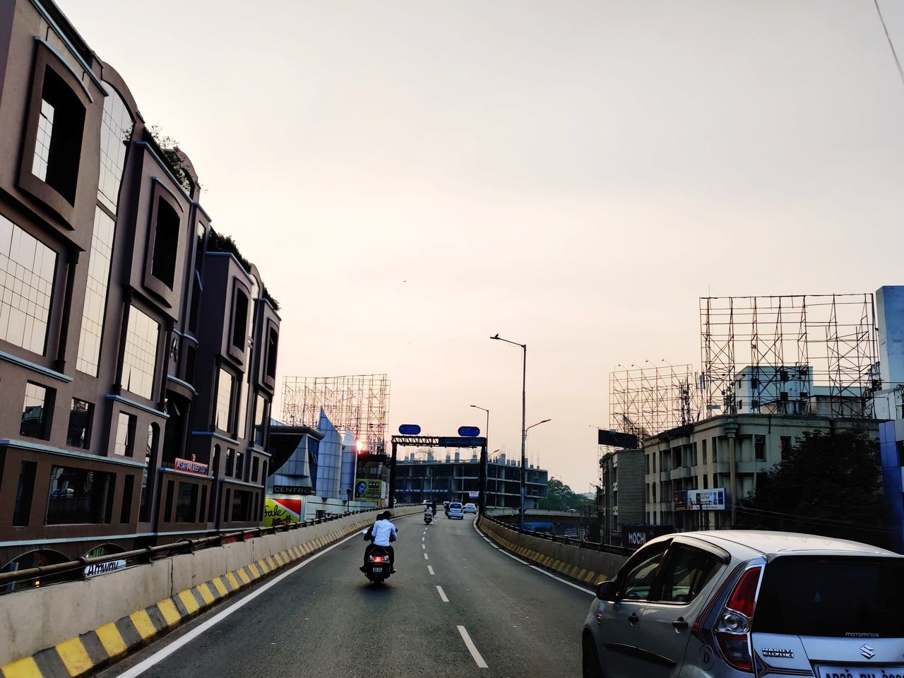 CARS ON STREET BY BUILDINGS AGAINST SKY