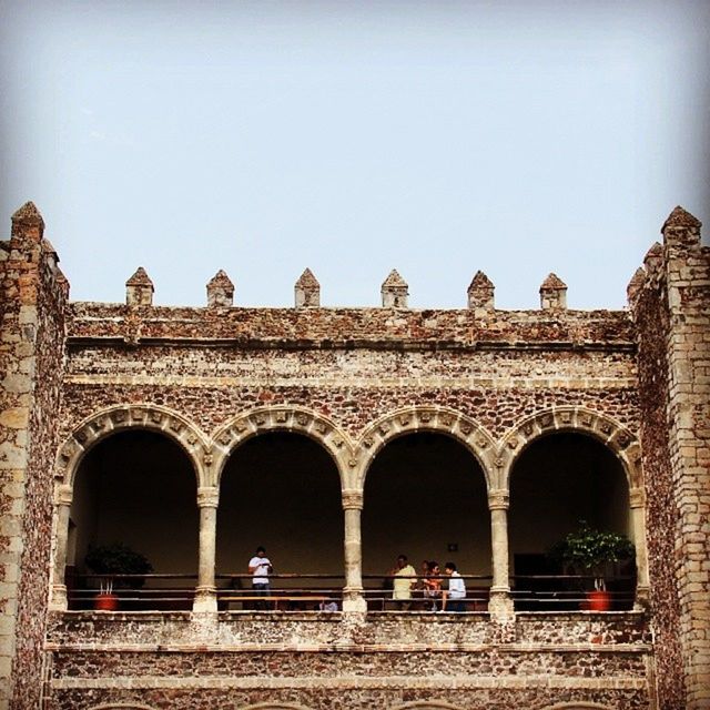 architecture, arch, built structure, building exterior, window, old, history, clear sky, low angle view, abandoned, entrance, old ruin, facade, day, the past, sky, obsolete, building, outdoors, damaged