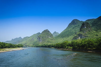 Scenic view of mountains against clear blue sky